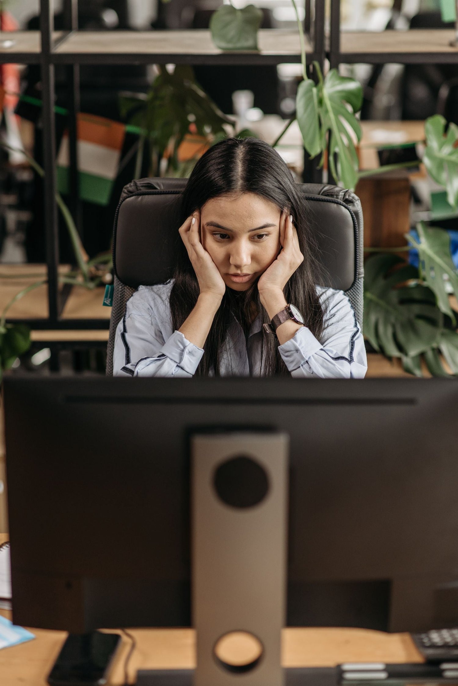 Woman pressing her fingers to her temple, reaching for a word that will not come, the midlife brain fog moment