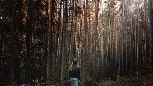 Woman doing a walking meditation on a quiet path, walking meditation for menopause stress relief